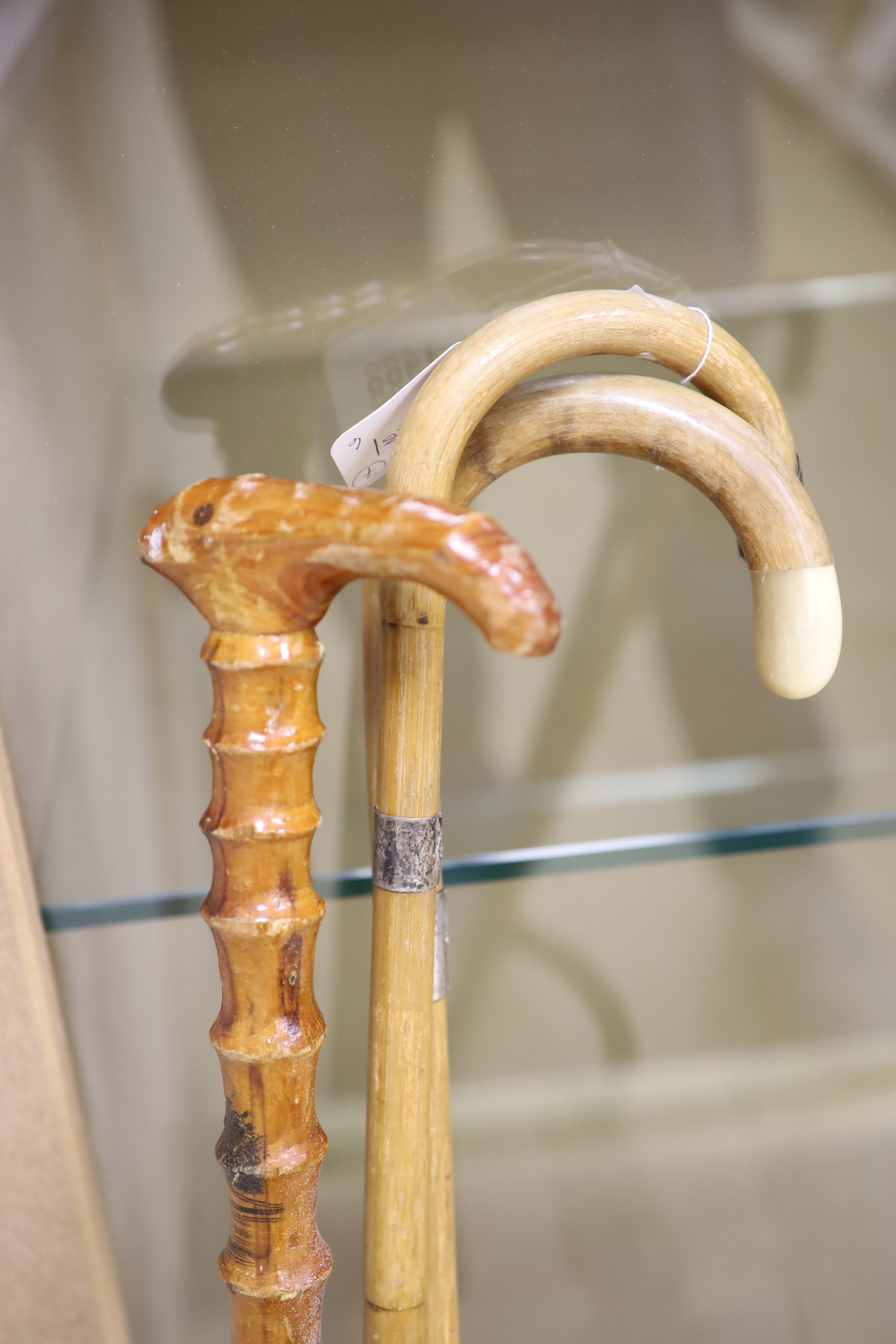 A collection of 7 cane/bamboo and silver-mounted walking sticks